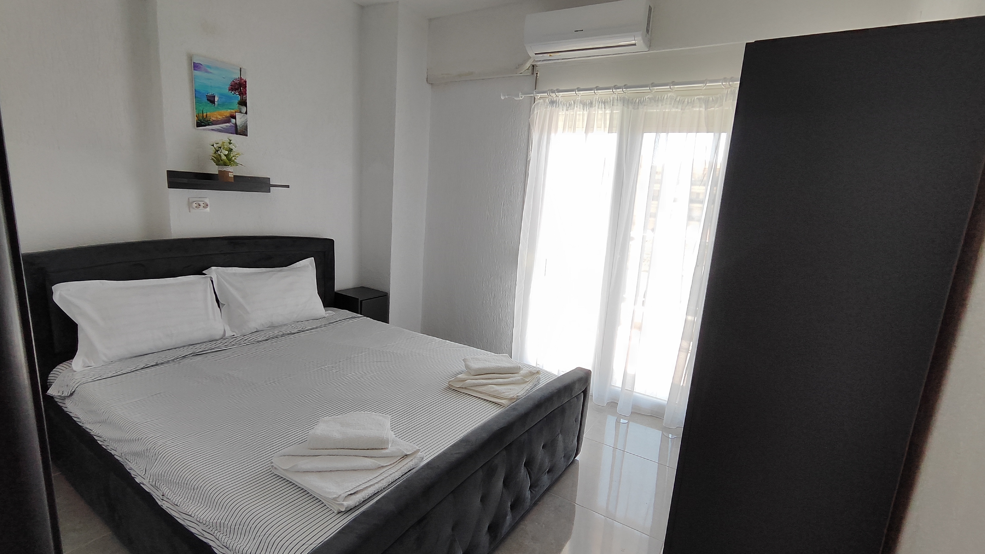 Bedroom with a luxurious upholstered double bed and a wardrobe