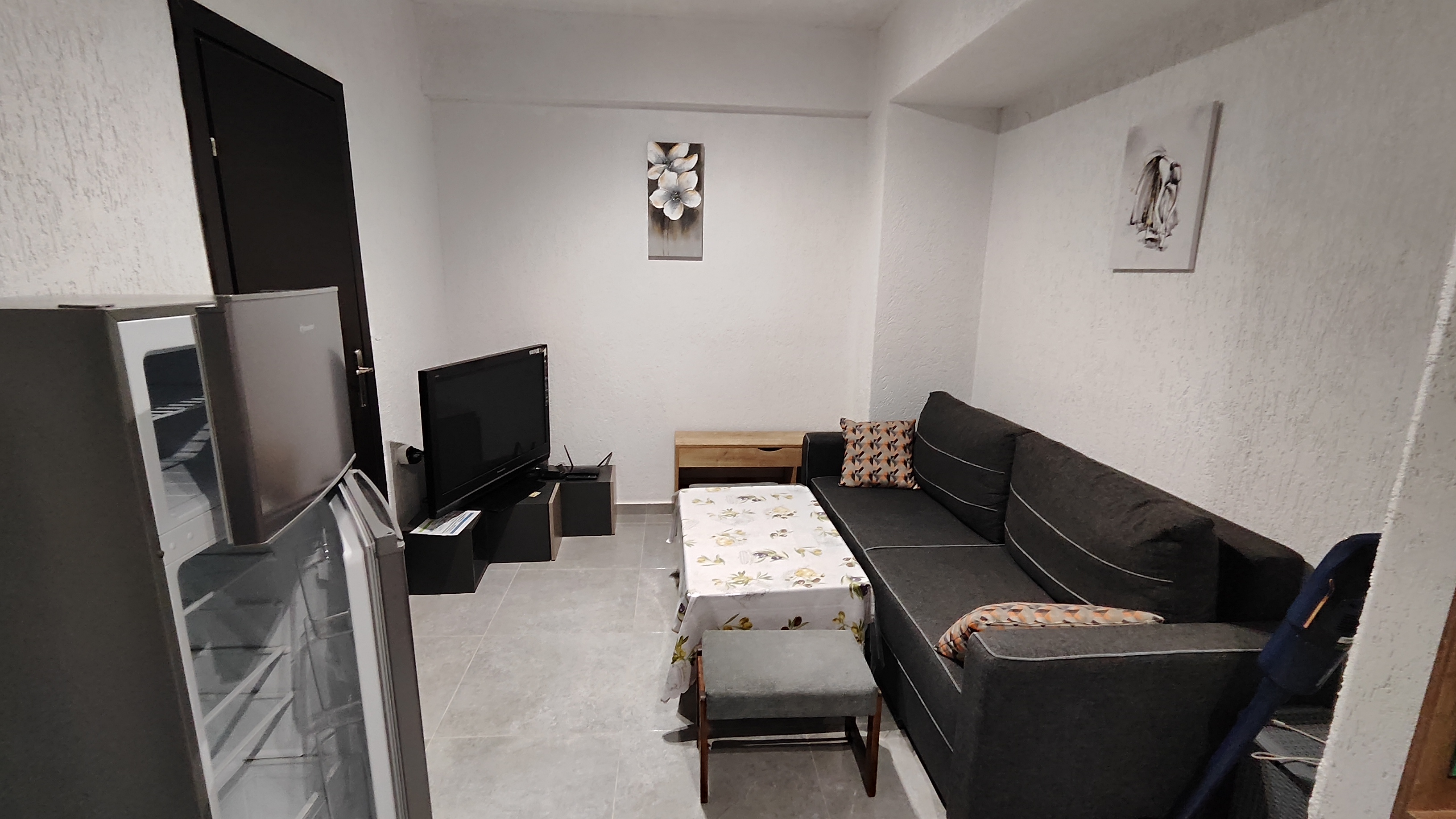 Bright living room with a daybed, coffee table and doors opening onto the balcony